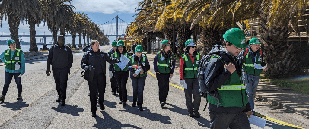 A group of SFFD Firefighters and NERTs walking down the street.