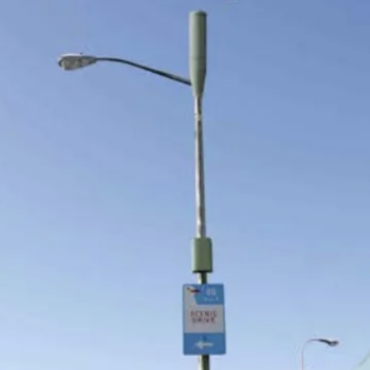 A street light pole with a Cellular telephone antenna mounted on top.